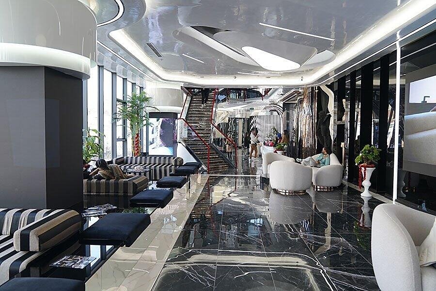 Lobby of Lema Dental Clinic in Istanbul with marble floor and open staircase